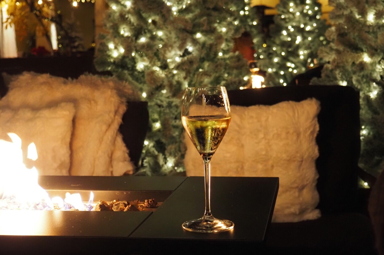A glass of champagne beside the fire pit