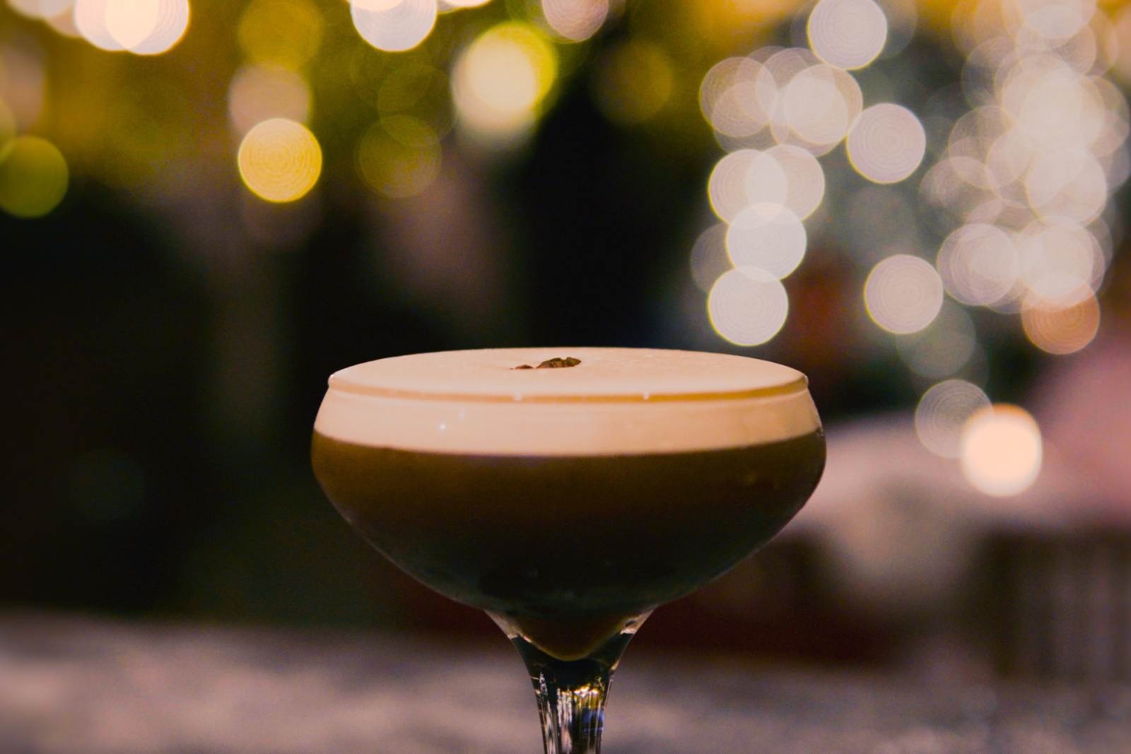 Espresso martini against holiday lights